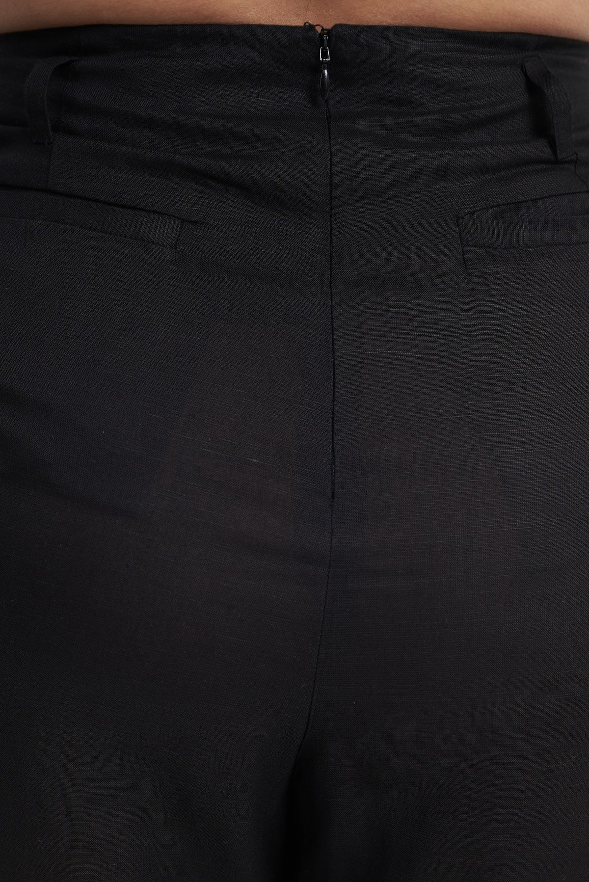 Waistband and zip detail on black seamless tailored trouser