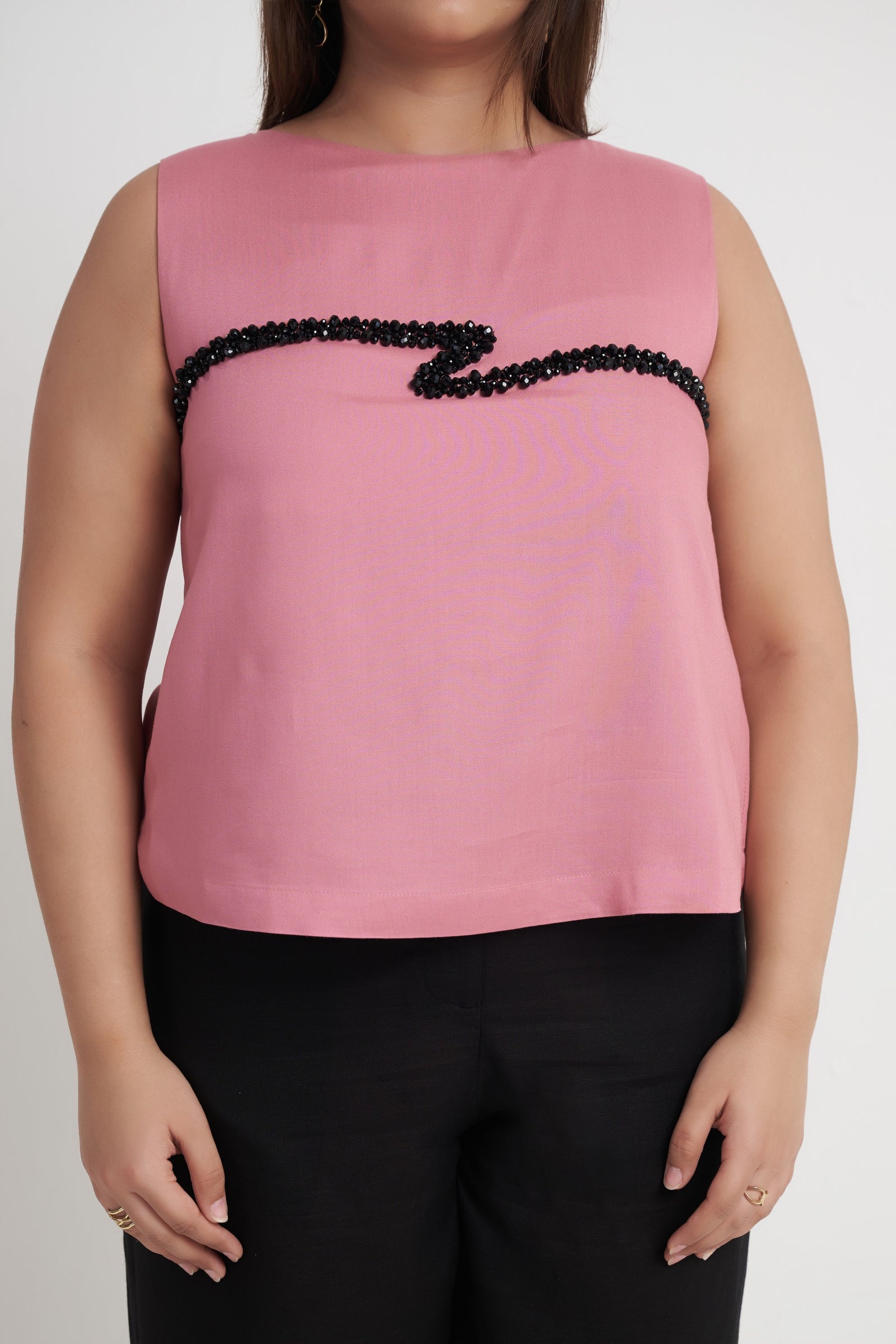 Close up of beaded cord embroidery on dusty rose sleeveless top