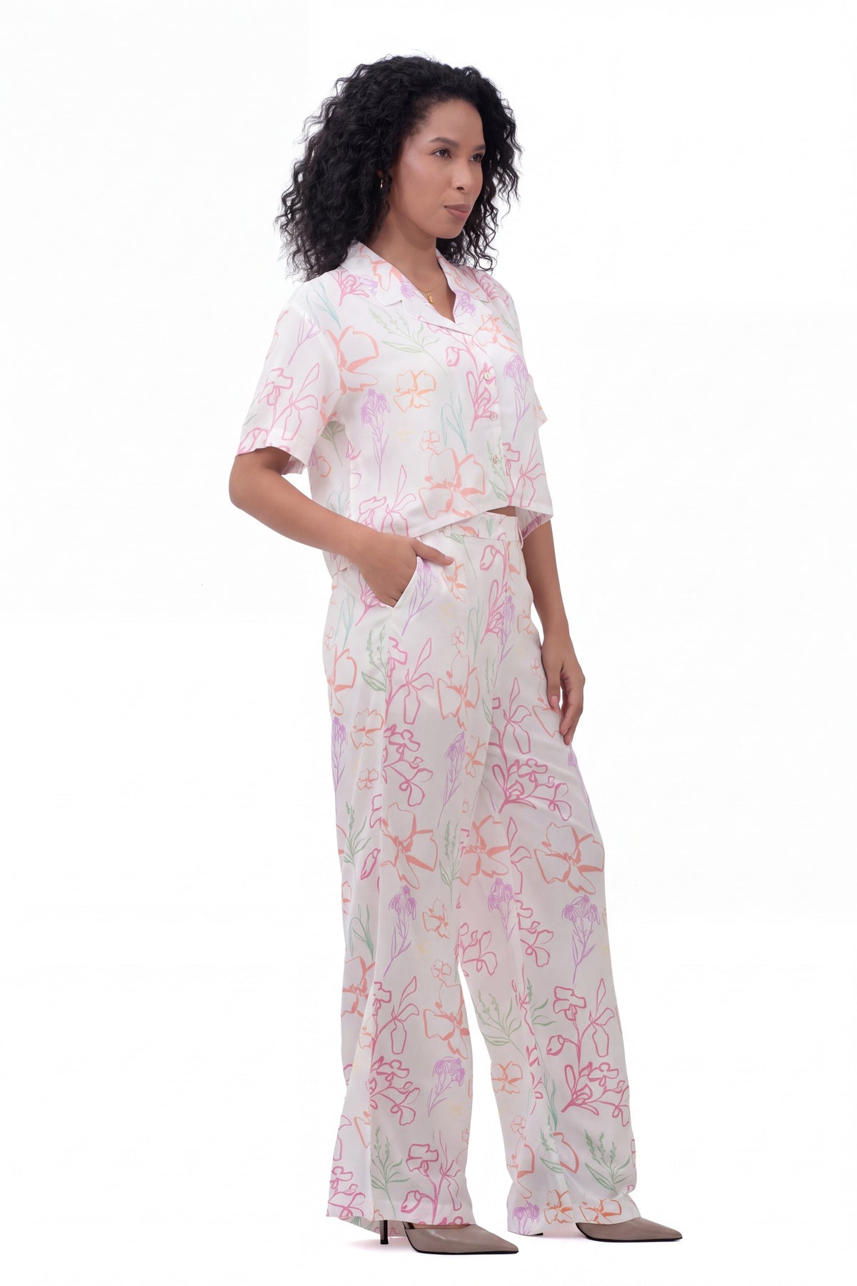 Flora Co-ord Set - cropped floral shirt with matching wide-leg trousers, side view with hand in pocket