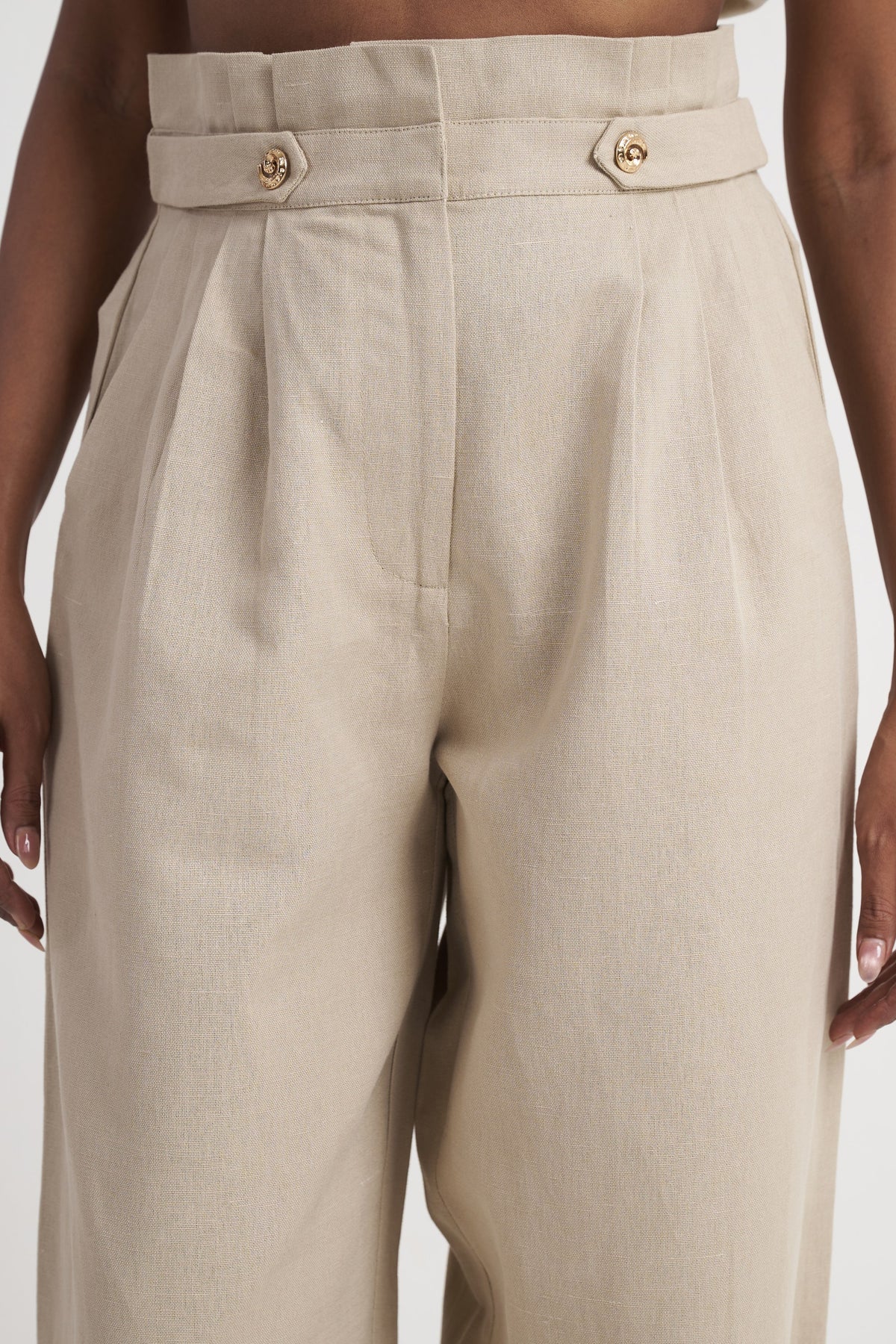 Zykaz High-Rise Pleated Tapered Trouser in White Onyx — banded waist and button tab detail