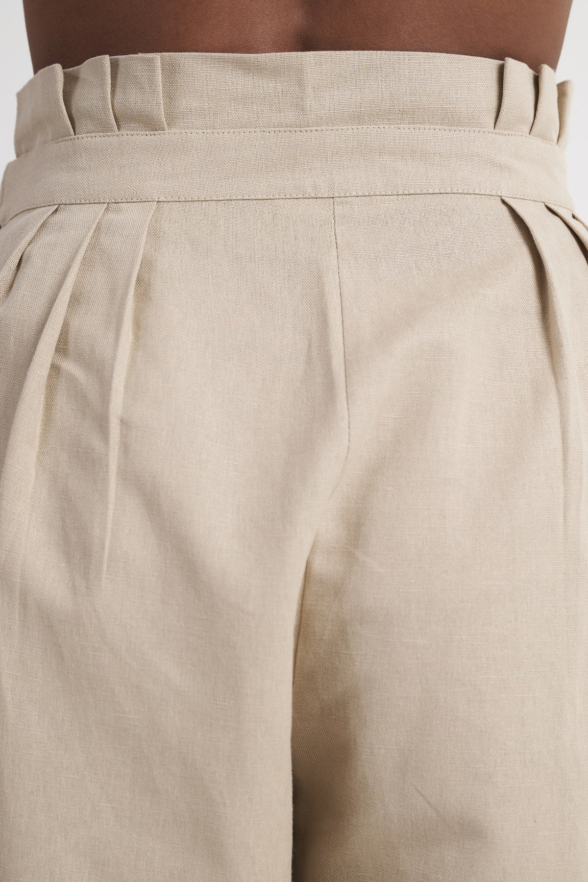Zykaz High-Rise Pleated Tapered Trouser in White Onyx — back waist detail