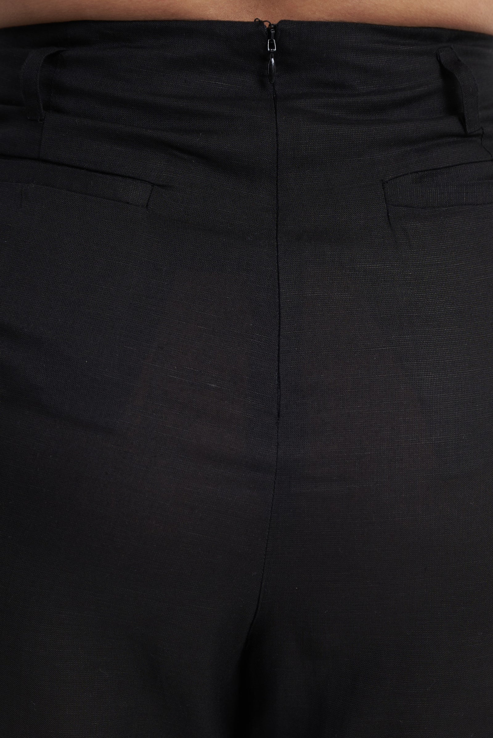 Waistband and zip detail on black seamless tailored trouser