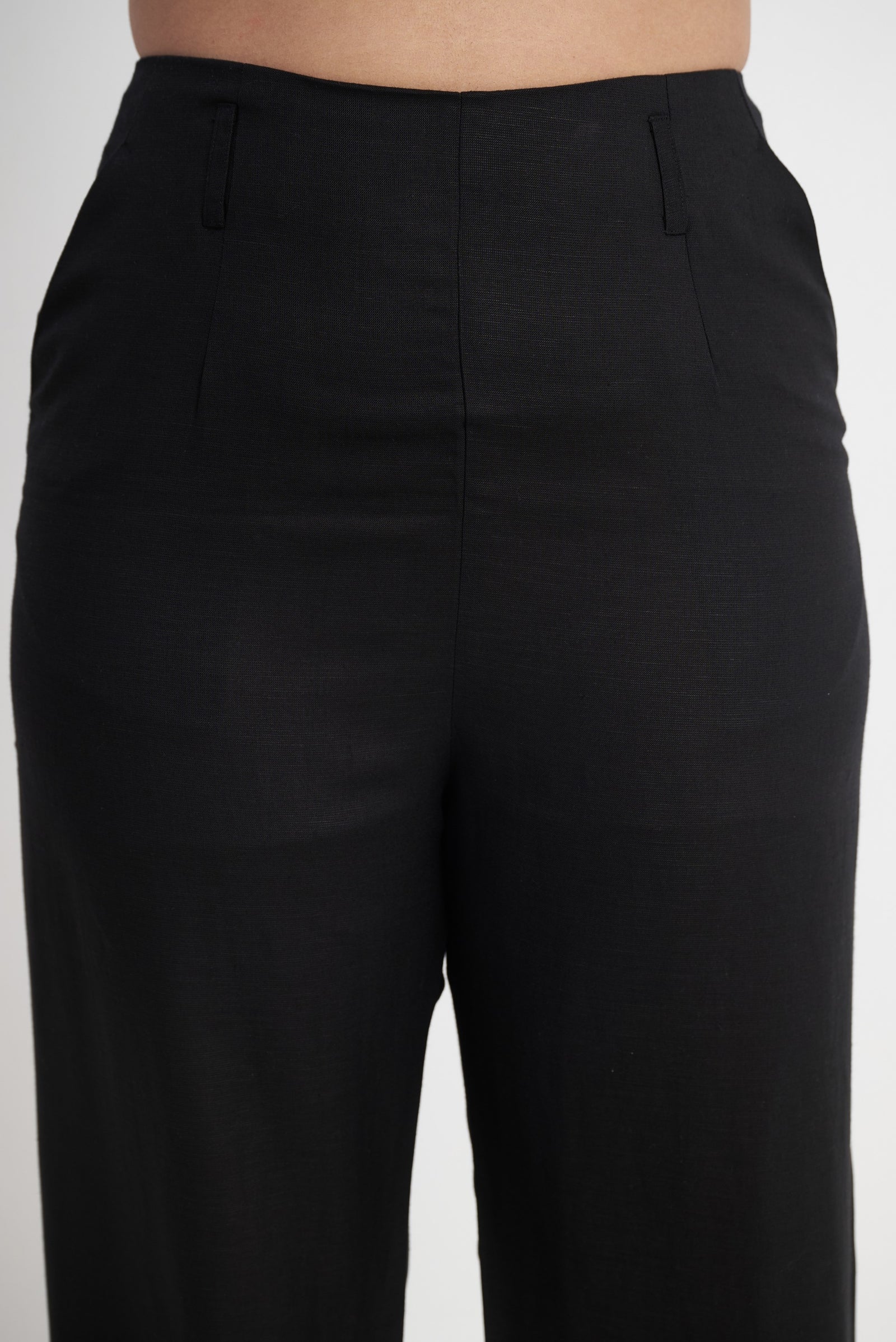 Seamless side construction detail on black trouser