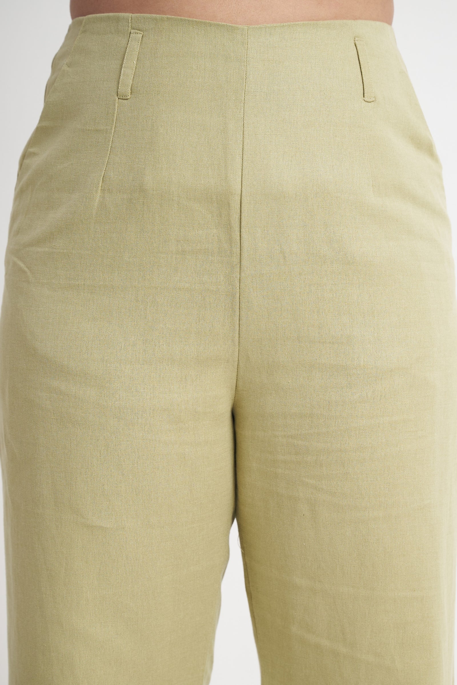 Waistband and belt loop detail on sage green tailored trouser