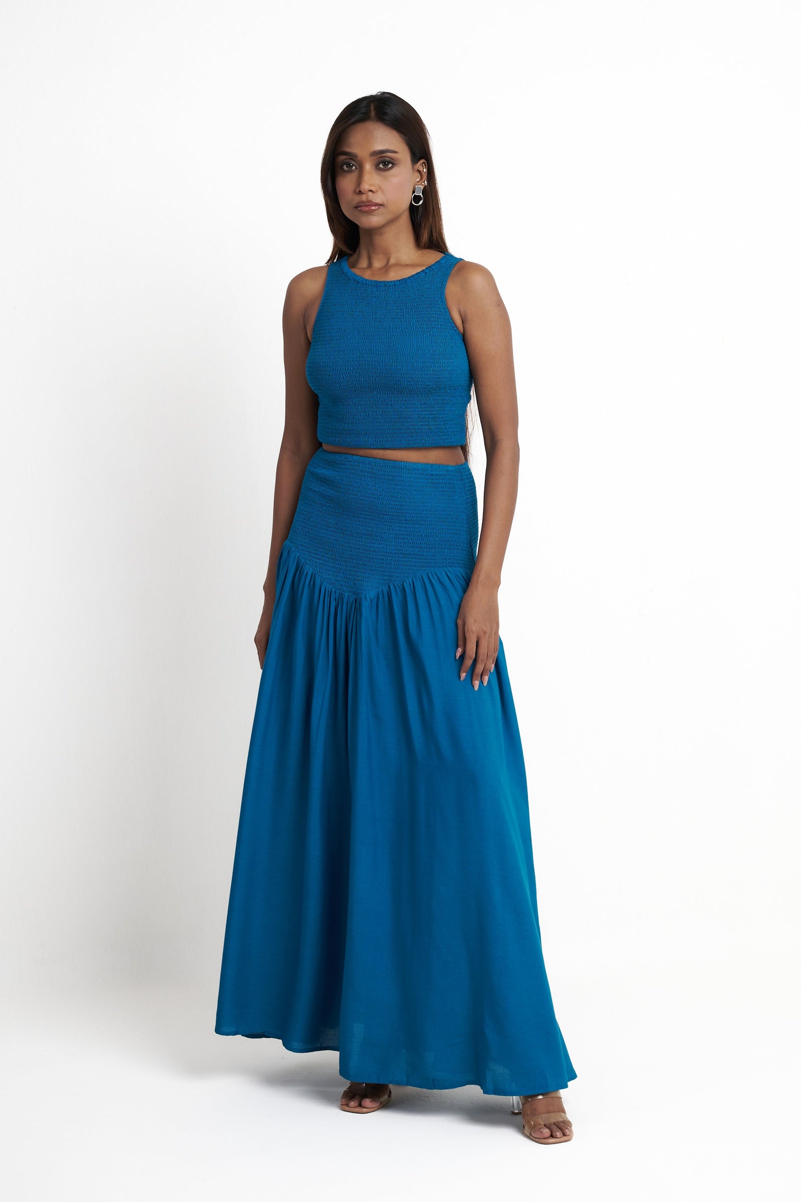 Smocked halter neck crop top for women in enamel blue styled with matching skirt